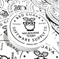 a pile of round white die cut stickers